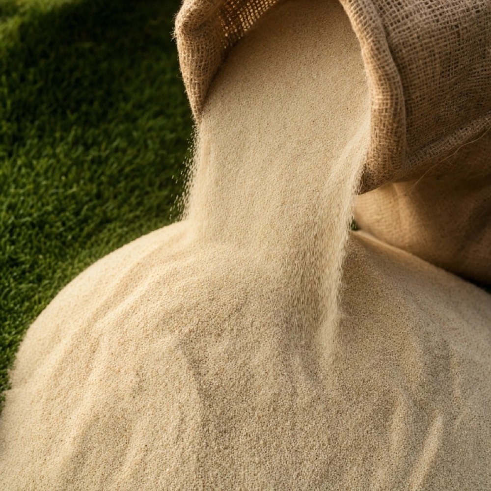 Kiln-dried sand pouring from a plain sack